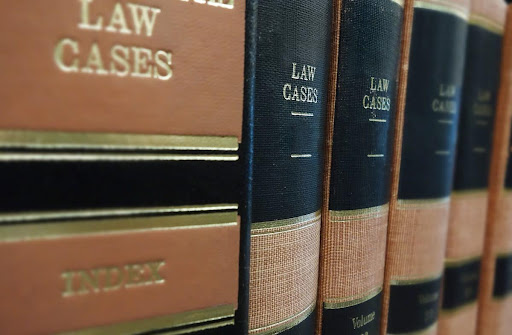 Law books in a library to represent researching Frontline insurance lawsuits