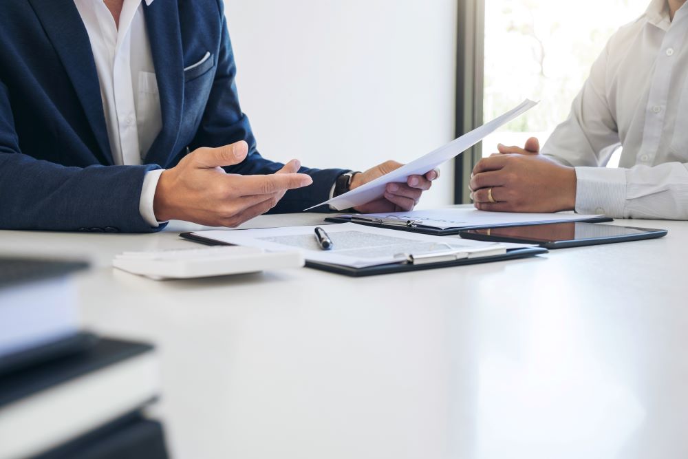 Lawyer discussing paperwork with a client